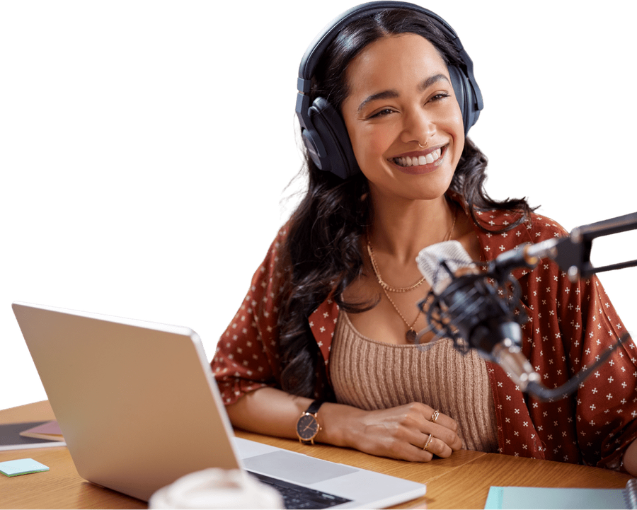 A podcast host recording at a desk with headphones and a microphone