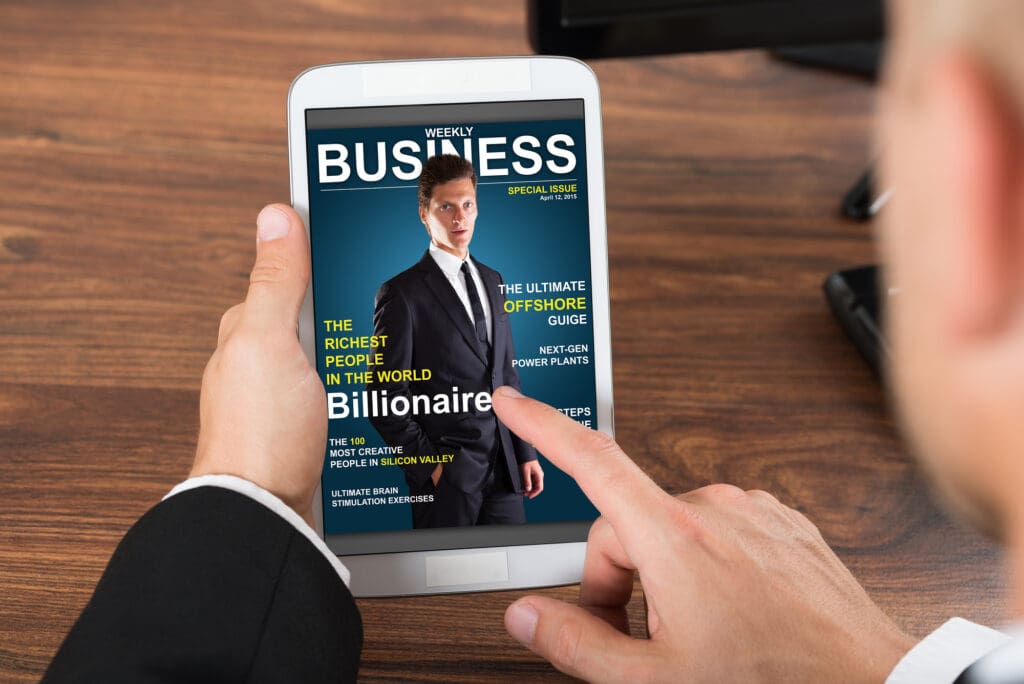 Close-up Of Businessperson Holding Mobile Phone With Business News On Screen ** Note: Shallow depth of field